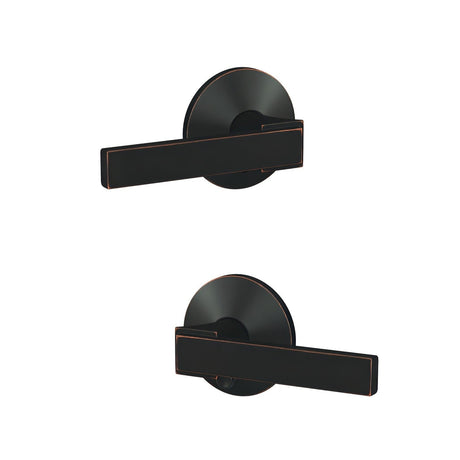 Schlage FC21NBK716KIN aged bronze passage & privacy door lever